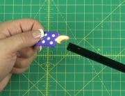 Sealing purple ribbon with lighter